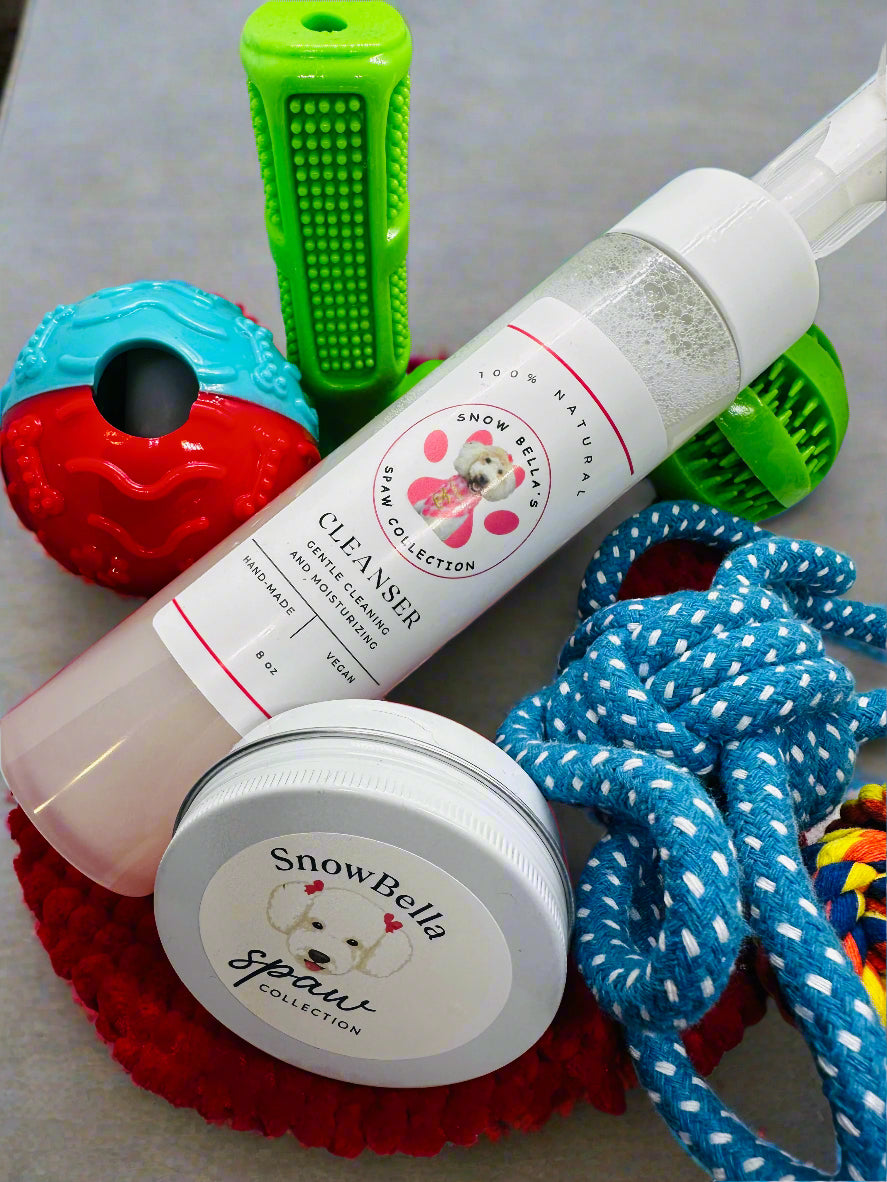 Snow Bella pet care products including a bottle and jar with toys in the background.